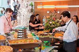 On the day of the event, caterers work tirelessly behind the scenes